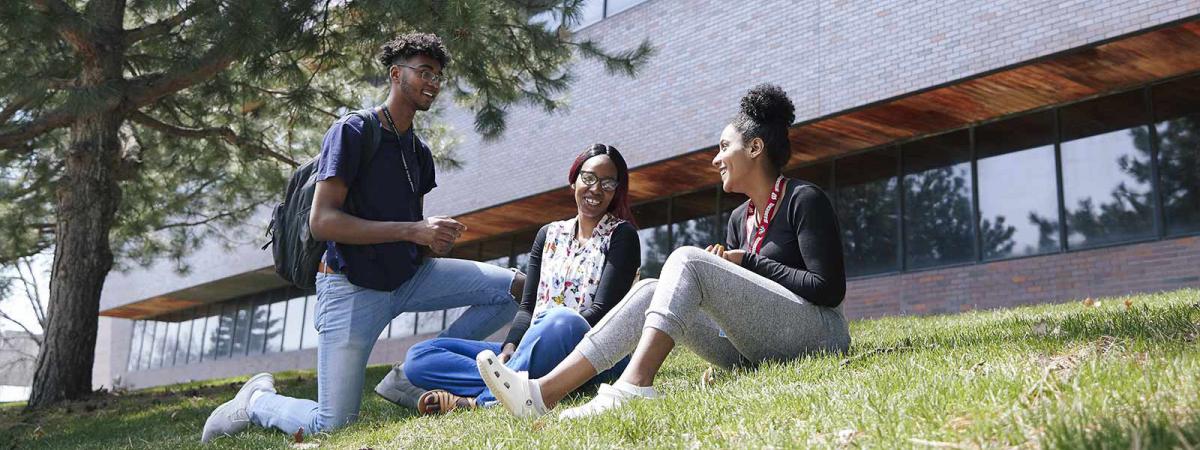 Campus Life at Minneapolis College 3 students on the lawn in front of the Kopp Building at Minneapolis College