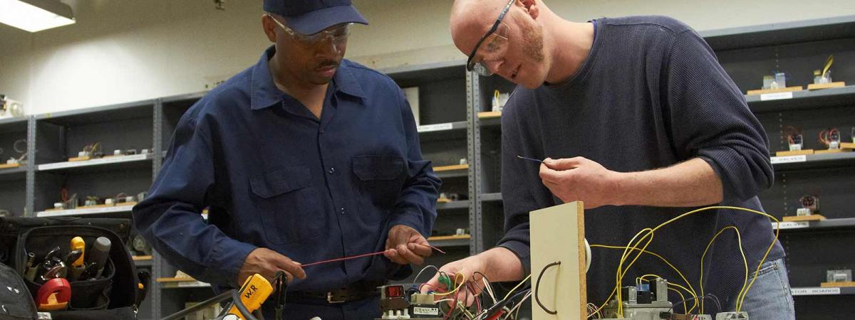 Heating, Ventilation, Air Conditioning and Refrigeration at Minneapolis College Two students sorting out an electrical problem in class