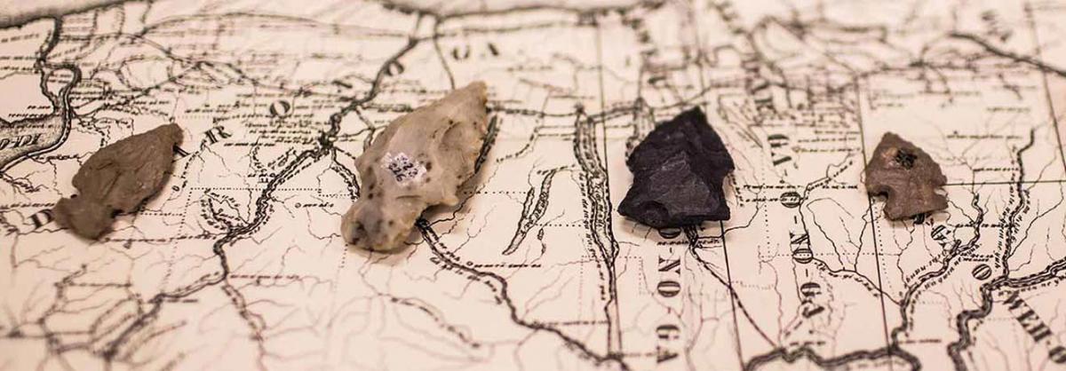 Anthropology Program at Minneapolis College map with arrowheads laying on top of it