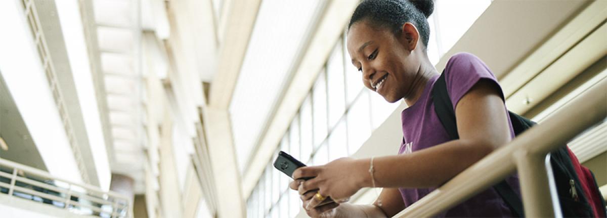 Transfer Out from Minneapolis College student checking phone