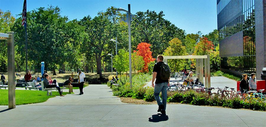 Minneapolis College Accessibility is for Everyone student walking across the Minneapolis College Plaza