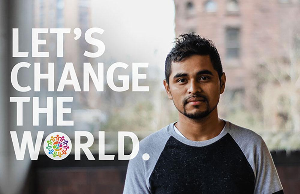 Student scholar posing for 'Let's Change the World' slogan.
