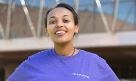 Alumna Scholar Eden at Minneapolis College Eden in front of skyway